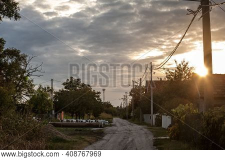 Unpaved Non Asphalted Road And Street, A Dirtpath, In A Village At Sunset In Ovca, A Rural Settlemen