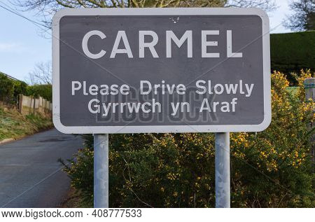 Carmel, Flintshire; Uk: Feb 11, 2021: A Place Name Sign At The Entrance To The Village Of Carmel Inc
