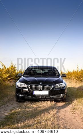 Kherson, Ukraine - June 2019. Bmw 5-series F10 In A Black Color In The Vineyards.
