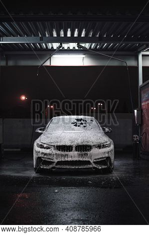Kyiv, Ukraine - November 2019. Bmw M3 F80 At The Night Carwash Station In The Foam.