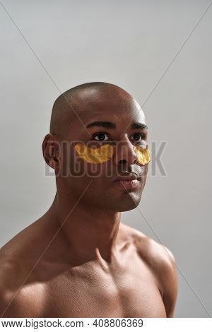 Orange Beauty Masks Made Of Hydrogel Healing Wrinkles Below Multiracial Adult Eyes While He Focusing
