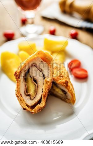 Traditional French Cuisine Chicken Roll Cordon Bleu Or Gordon Blue With Cheese, Ham And Potatoes