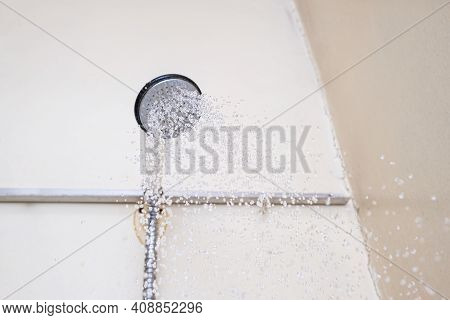 Water Flowing From An Old Shower Head With Ceramic Handle With Limescale Needed To Be Replaced Or De