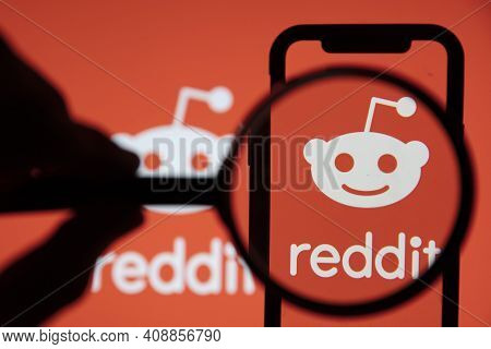 London, Uk - February 2021: Reddit Logo Seen Under A Magnifying Glass
