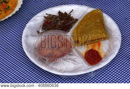 Close-up View Of Packaged Indian Street Food Chapathi,curry, Pickle And Fried Vegetable Curry