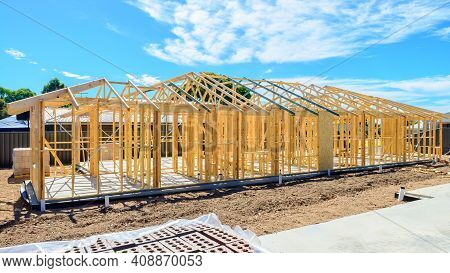 New Australian House Timber Frame Installation Process At Construction Site On A Bright Summer Day
