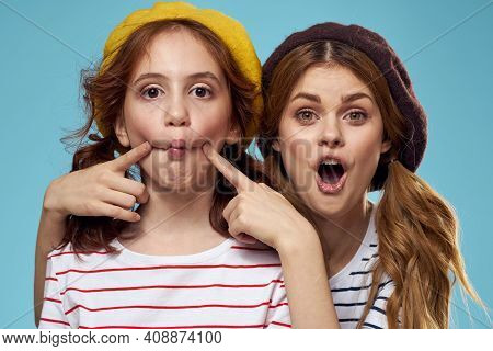 Mom And Daughter Striped T-shirts Hugs Fun Lifestyle Blue Background