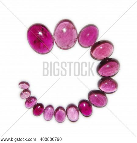 Many Different Size Pink Tourmaline Cabochons On White Background