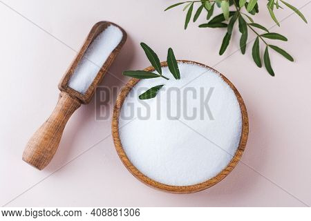 Natural Sweetener In A Wooden Bowl On A Pink Background. Sugar Substitute. Erythritol.