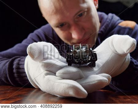 Gomel, Belarus - February 16, 2021: Portrait Of A Collector Of Retro Car Models On A Black Backgroun
