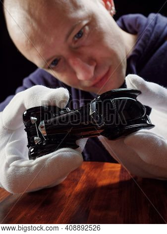 Gomel, Belarus - February 16, 2021: Portrait Of A Collector Of Retro Car Models On A Black Backgroun