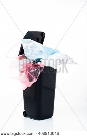 Unsorted Waste In The Bin. All Kinds Of Rubbish In The Trash Can. Vertical Frame.