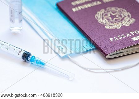 Vilnius, Lithuania - February 19 2021: Syringe With Needle, Vial, Surgical Face Mask And Passport Or