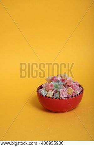 Red Bowl Of Rahat Lakoum Isolated On Yellow Background Vertical Image. Turkish Sweet Concept. Image 
