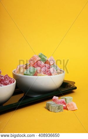 Two Bowls Of Rahat Lakoum On A Tray Isolated On Yellow Background Vertical Image. Turkish Sweet Conc