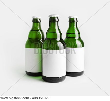 Three Glass Green Beer Bottles With With Blank Labels.