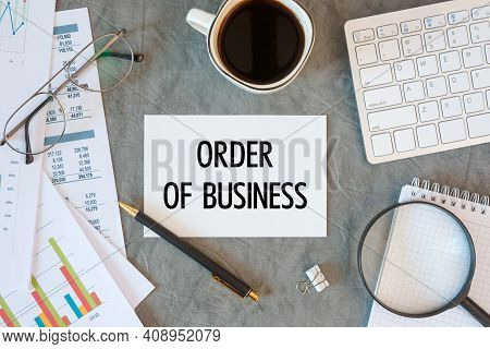 Order Of Business Is Written In A Document On The Office Desk With Office Accessories, Coffee, Diagr