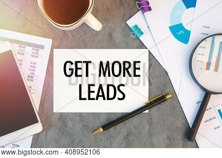 Get More Leads Is Written In A Document On The Office Desk With Office Accessories, Coffee, Diagram 