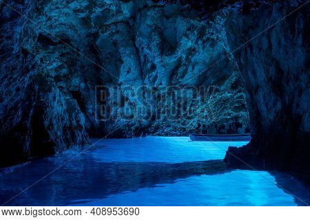 Bisevo, Croatia - Aug 16, 2020: Tourists On A Boat In Serene Blue Cave Near Komiza Island