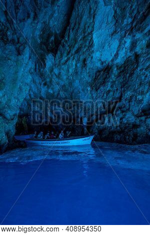 Bisevo, Croatia - Aug 16, 2020: Tourists On A Boat In Enter Serene Blue Cave Near Komiza Island