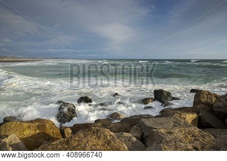 Costa Da Caparica, Portugal - April 17, 2019: Surfing In The Costa Da Caparica Beach, A Famous Place