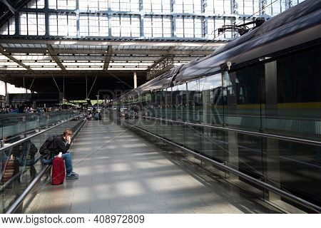 London, England July 2 2019: Traveller Waiting For The Eurostar Train At Kings Cross St Pancras Stat