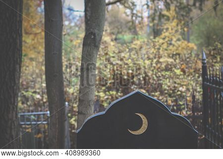 Old Islamic Cemetery, Funeral And Burial Of Muslim. A Grave With A Stone With Crescent Moon. Black G