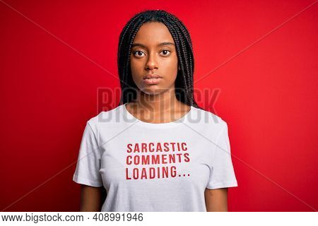 Young african american woman wearing sarcasm coments text on t-shirt over red background with a confident expression on smart face thinking serious