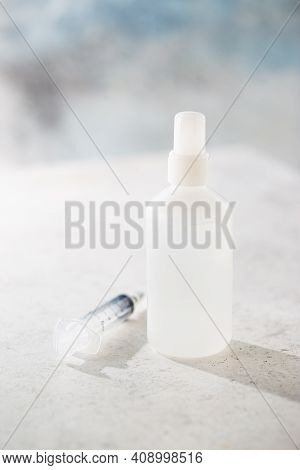 Medical Surgical Mask, Syringe And Bittles On White Background