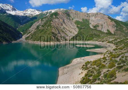 Amazing mountain lake with beautiful island and high coast