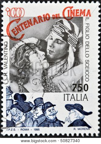 A stamp printed in Italy shows Rudolph Valentino in the film The Son of the Sheik