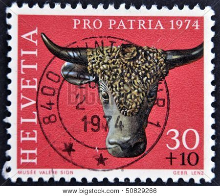 A stamp printed in Switzerland shows sculpture of a bull's head valere museum sion