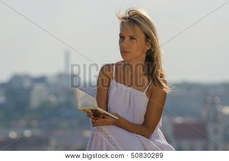 young woman reading book in Vilnius, Lithuania