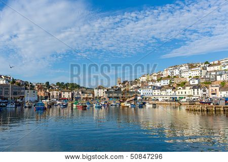 Brixham harbour Devon with boats moored on a calm summer day with blue sky