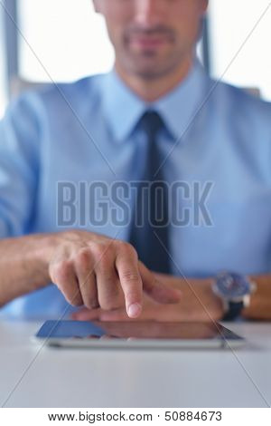 close-up of human hand  business man using tablet compuer at office