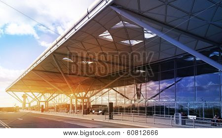 STANSTED AIRPORT, LONDON UK - 23 FEBRUARY 2014: airport building with sun light and sky reflection