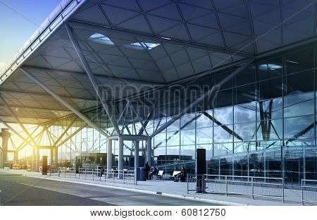 STANSTED AIRPORT, LONDON UK -  23 FEBRUARY 2014: airport building with sun light and sky reflection