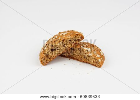 halves of avenaceous cookies sprinkled with flakes on a white background