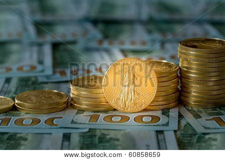 Gold Coins Stacked On New Design 100 Dollar Bills