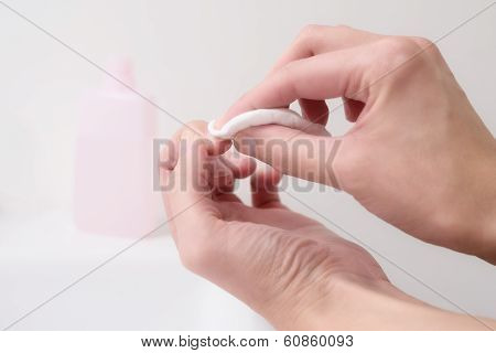 Woman Removing Nail Varnish With Acetone