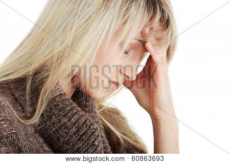 Young caucasian woman (student or businesswoman) with severe Migraine Headache holding hands to head 