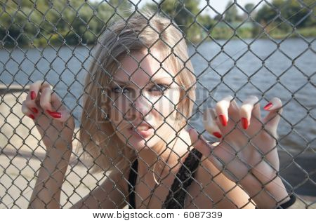 The girl has spitefully seized hands an  grid