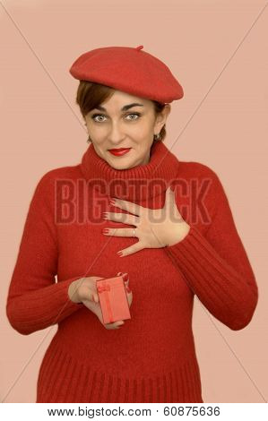 Woman in red with beret holding a gift