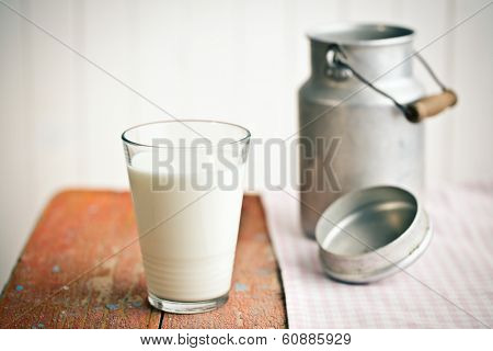 the milk in glass on old wooden table