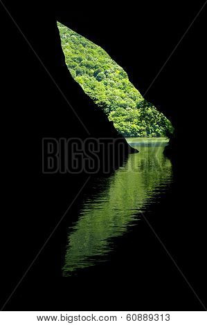 Reflection Of A Cave Entrance In The Water