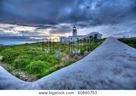 Menorca sunset in Faro Far de Caballeria Lighthouse at Balearic Islands es Mercadal
