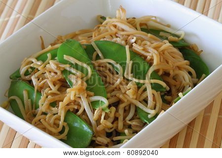 Bowl of egg noodles stir fried with snow peas and beansprouts