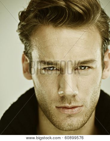 Portrait of a smart and handsome serious young man