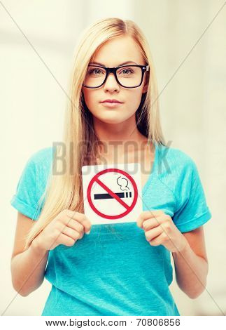 picture of woman with smoking restriction sign .