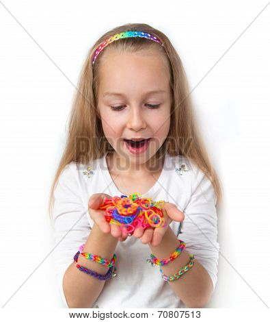 Loom bags craft. Little girl demonstrating her works.